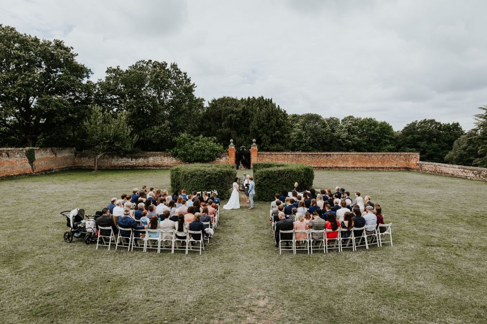 Georgie and Maz exchanging vows outside ceremony in the walled garden LGBTQ+ ceremony at Ufton Court in Reading.
