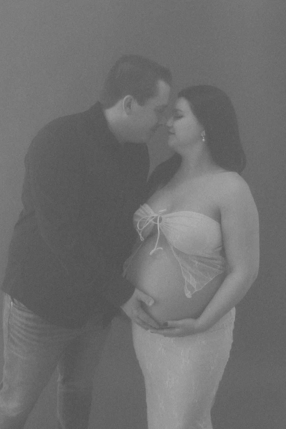 Dreamy black and white maternity photo with romantic pose.