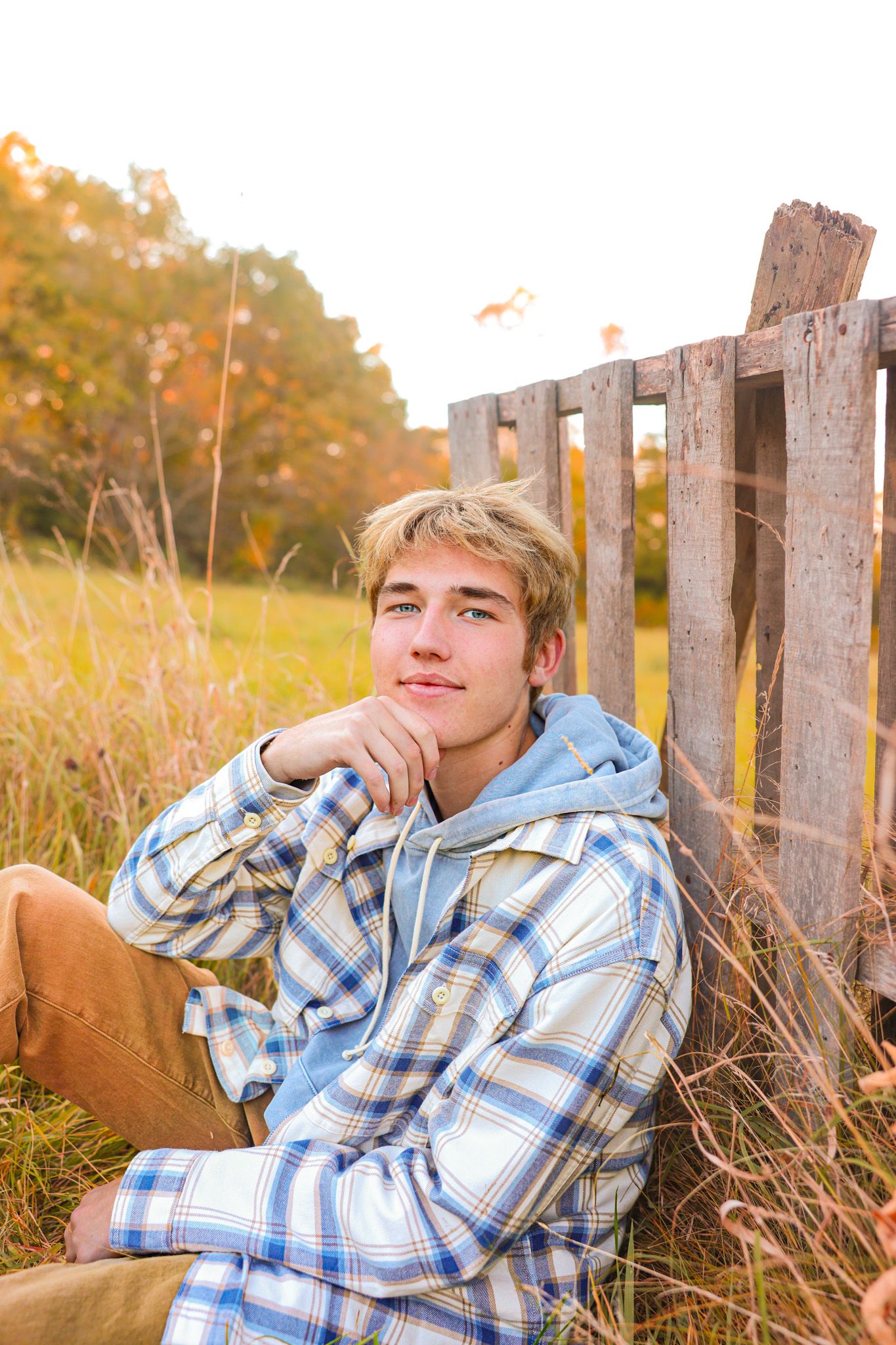 Male senior photo pose in the fall with a flannel.