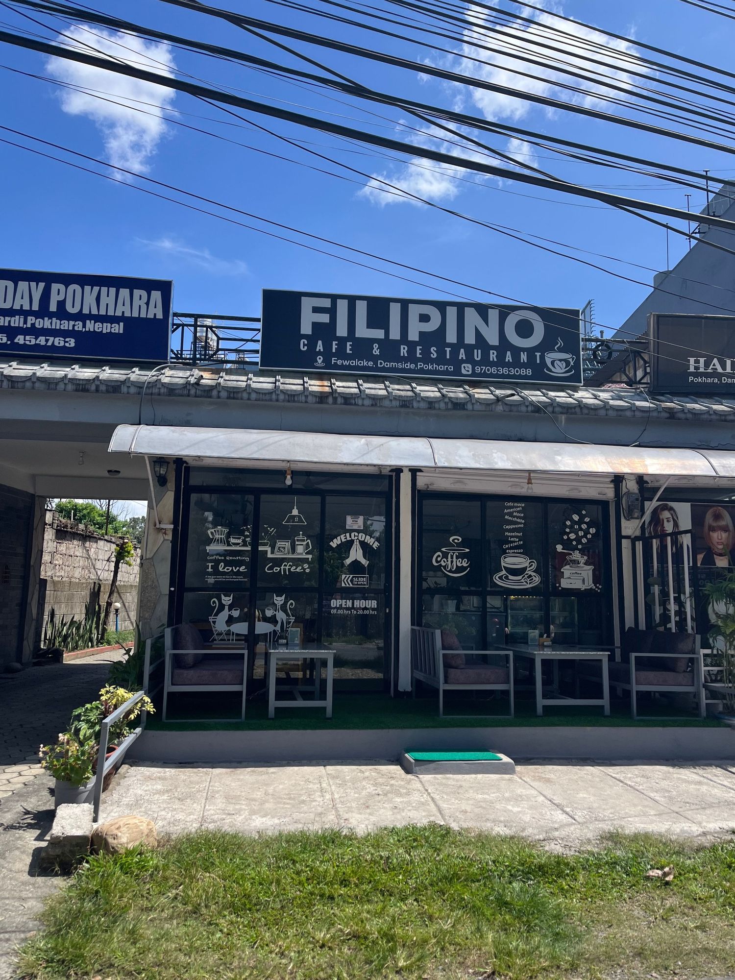 Strip mall exterior featuring Filipino restaurant and other businesses under blue sky.