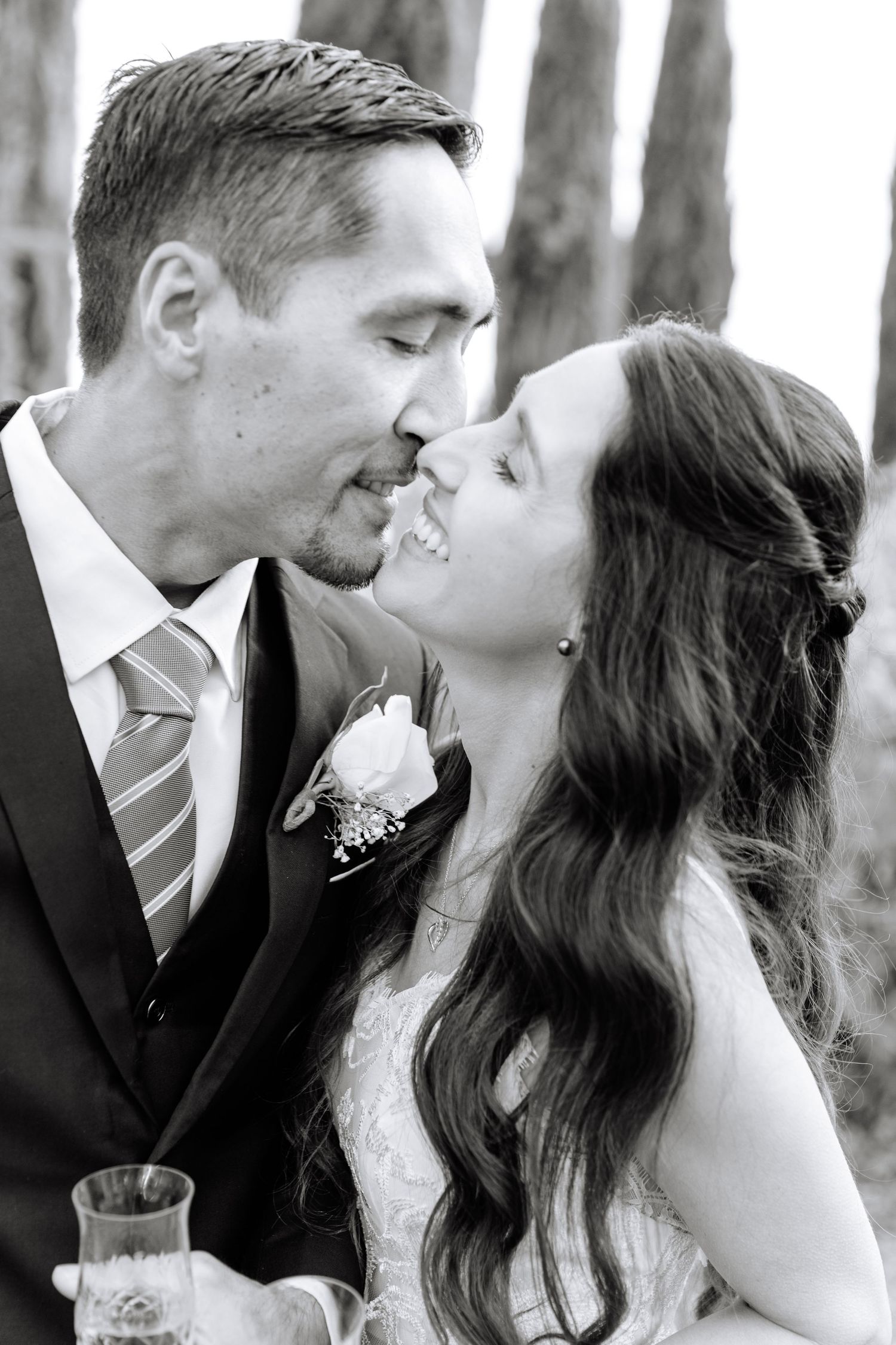 A romantic black and white photo sequence showing a couple sharing tender kisses in an outdoor setting.