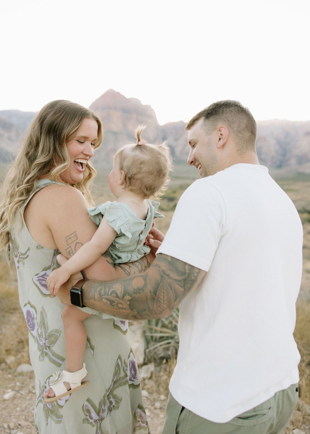 A family shares joyful moments together in a desert landscape setting.