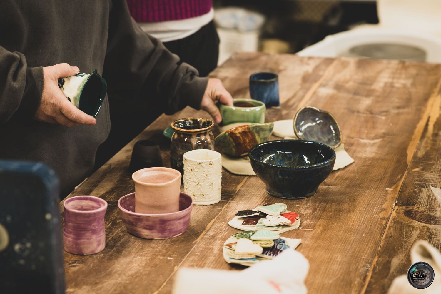 A rustic wooden table set with drinks and snacks at a casual gathering.