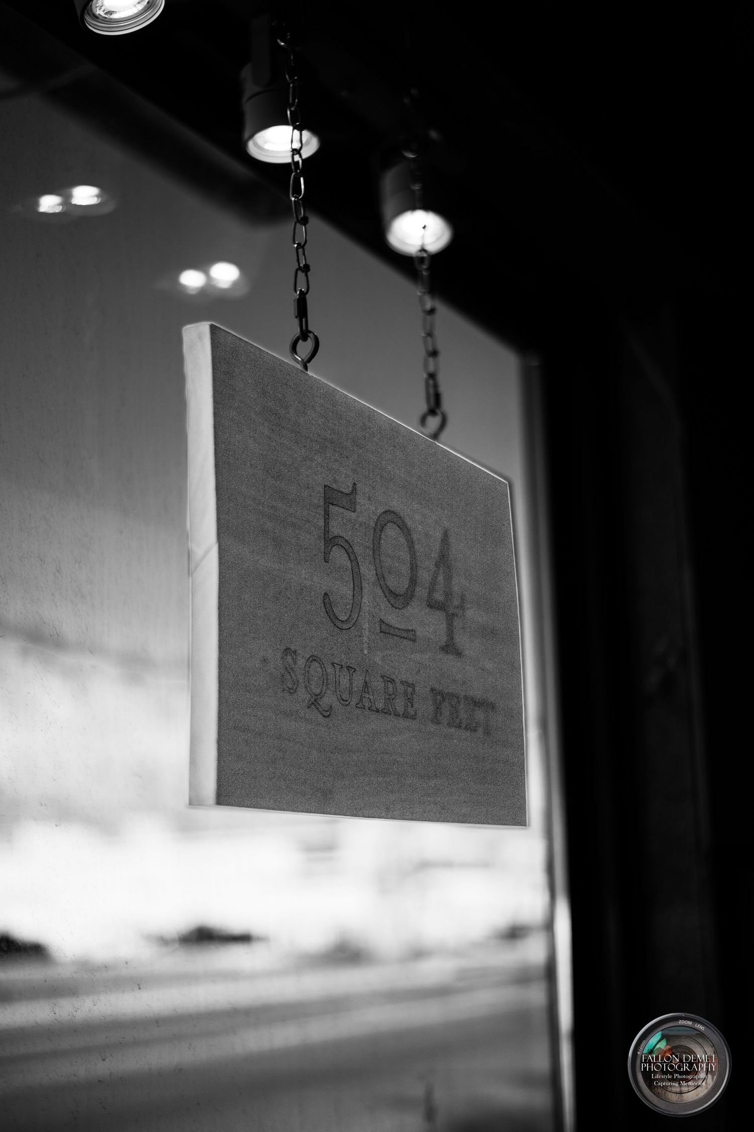 A hanging wooden sign reads '504' in black and white photography.