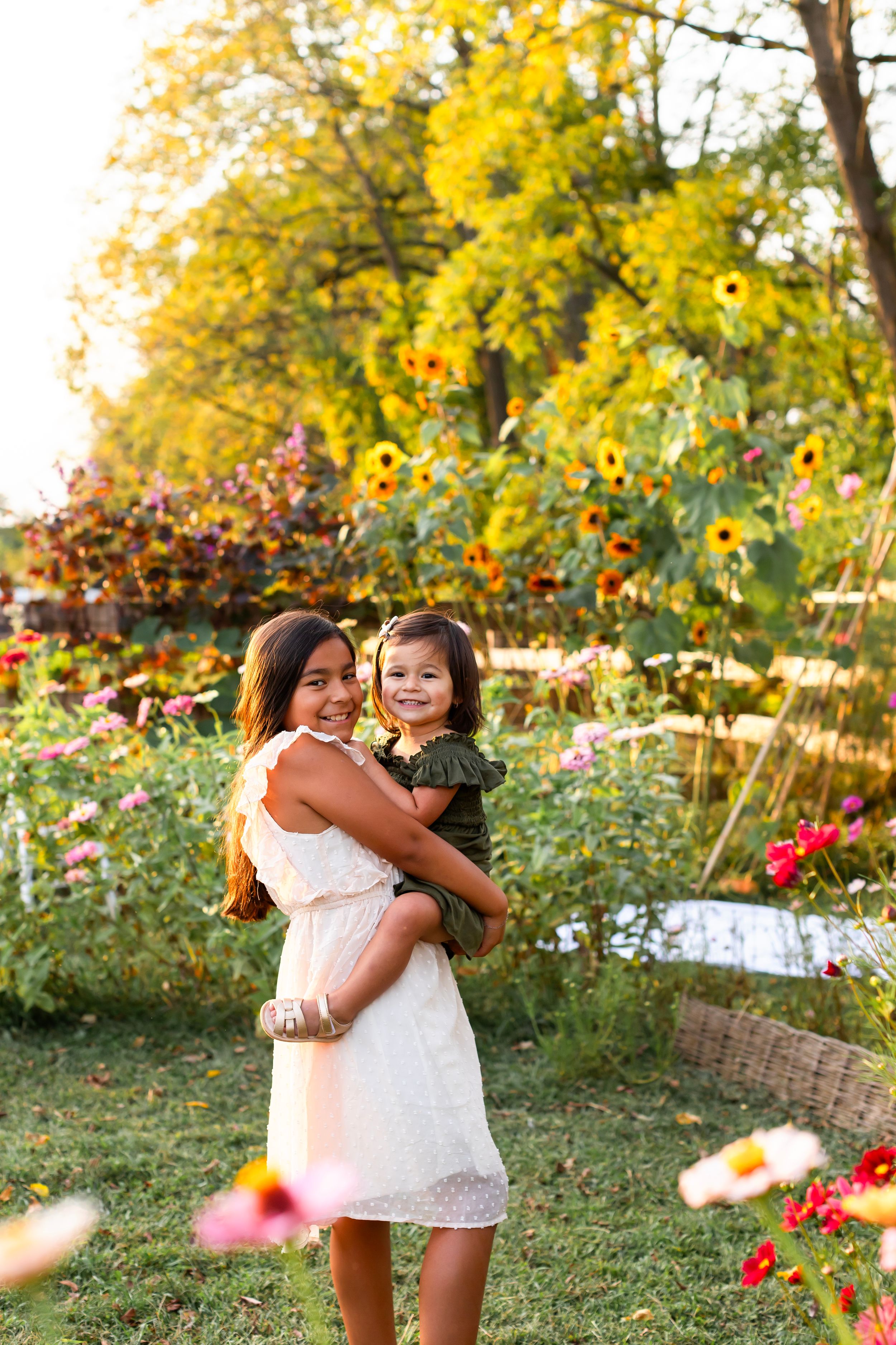 Mother and child embracing in beautiful garden with blooming flowers.