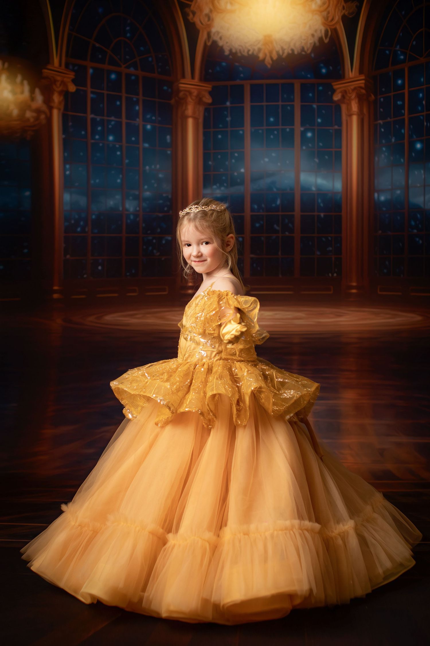 Ethereal golden ball gown with tiered skirt against dramatic dark background.