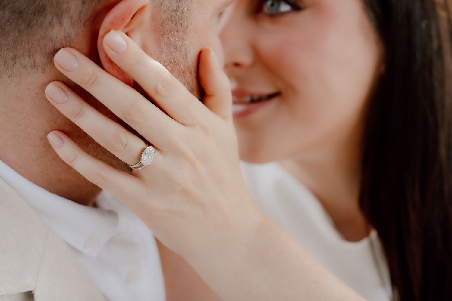 Close-up engagement photo of woman showing her ring while embracing her partner during a romantic couple photoshoot in Dubai