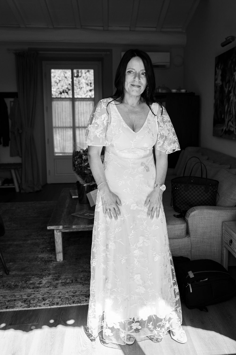 A series of black and white photos showing someone in a white lace dress indoors.
