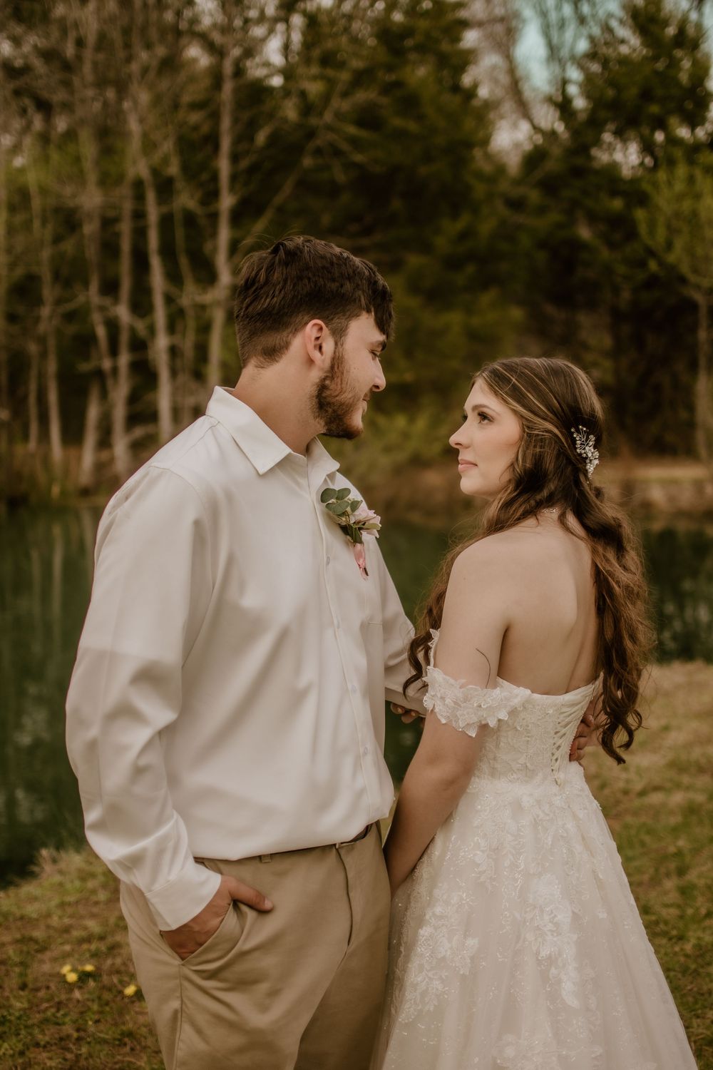 Romantic outdoor wedding portraits of couple in autumn setting with warm lighting.
