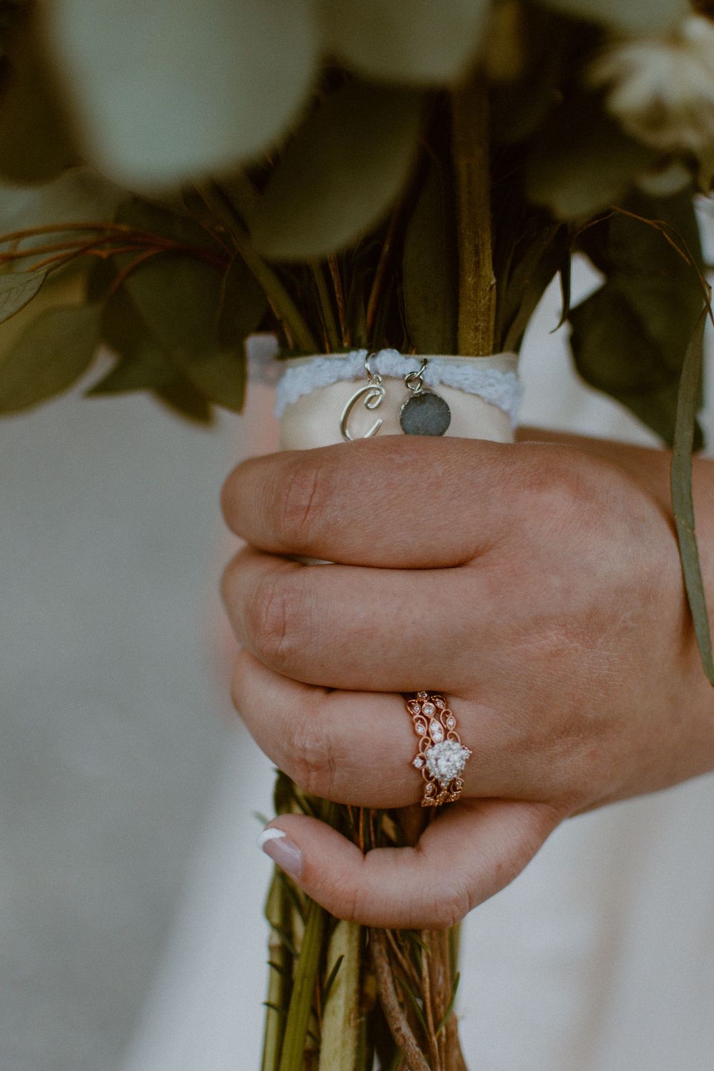 Close-up shots of hands holding a wedding bouquet with engagement ring details.
