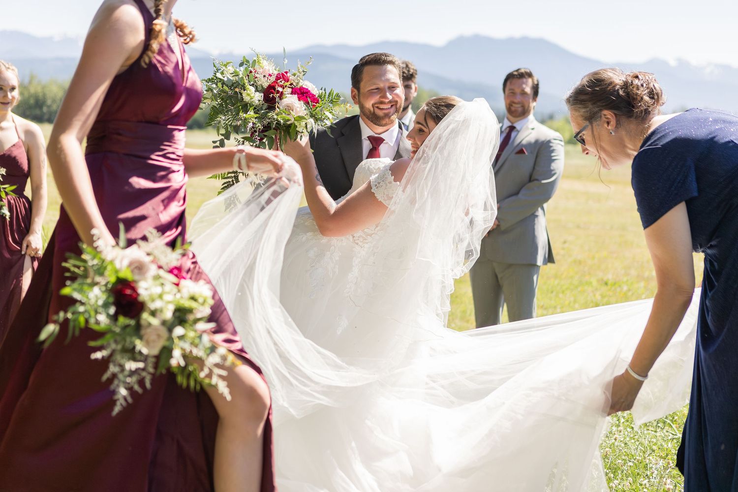 Wedding celebration in an outdoor mountain setting with flowing white dress.