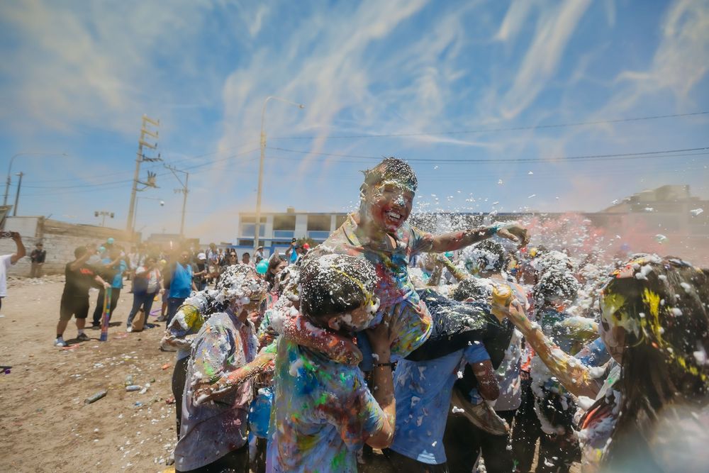 Rows of colorful plastic waste and debris scattered across a desert landscape under a cloudy sky.