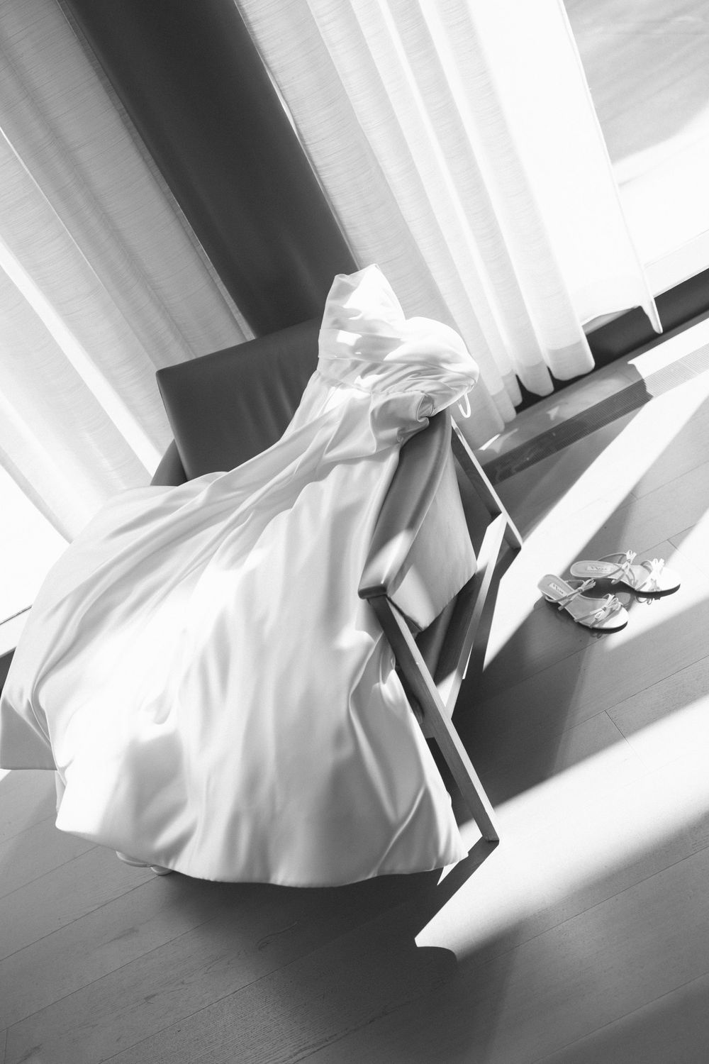 Abstract black and white photo of flowing white wedding dress fabric in motion.