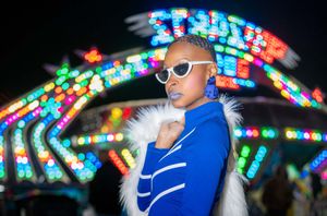 Fairground portrait session with carnival lights in Charleston.