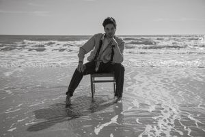 Black and white beach portrait of a man at Folly Beach.