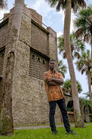 Historic stone fort wall in Summerville, SC decorative diamond pattern stands tall among palm trees in tropical setting.