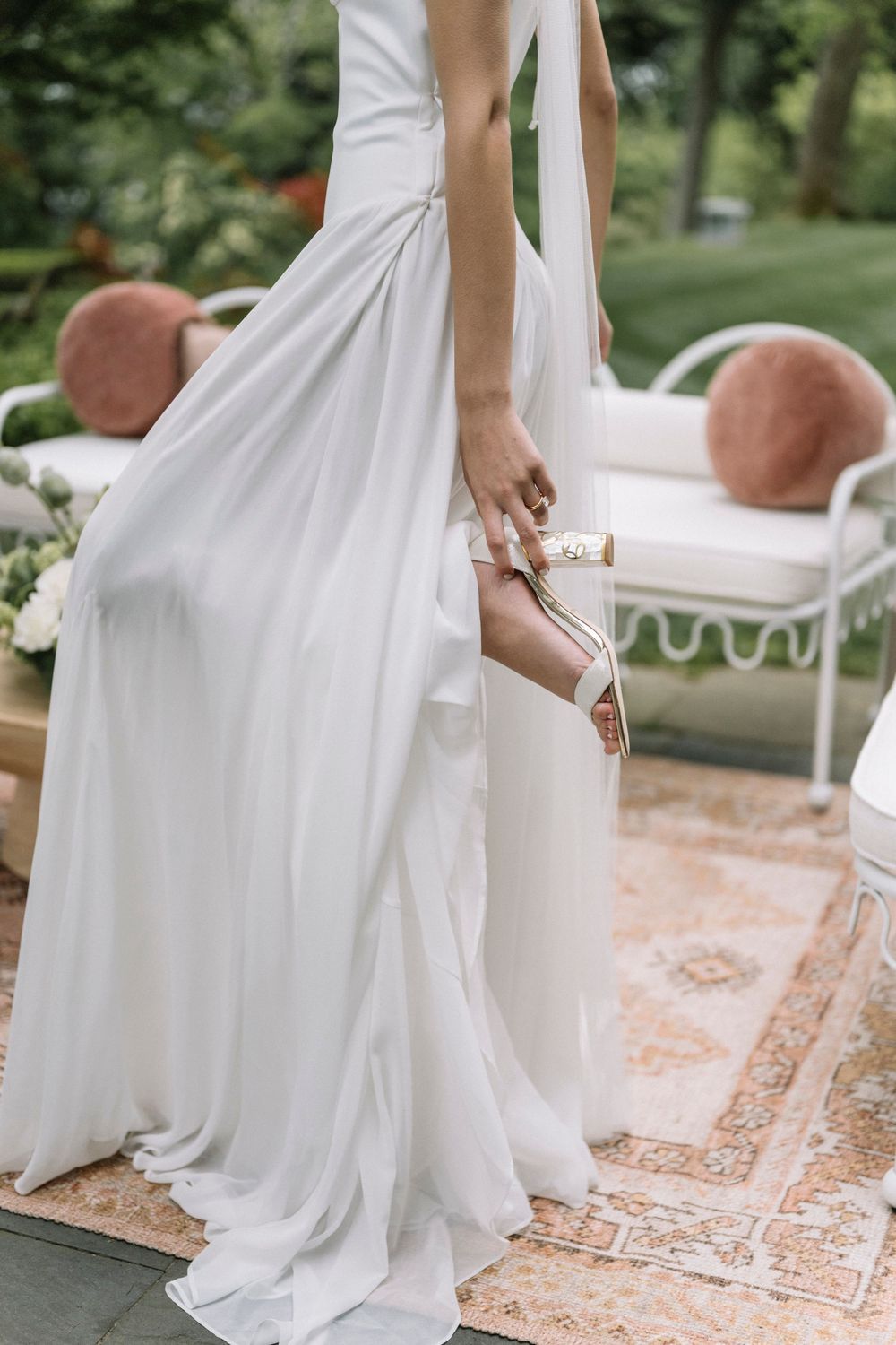 Series of elegant shots showing the flowing movement of a white wedding dress against a garden backdrop.