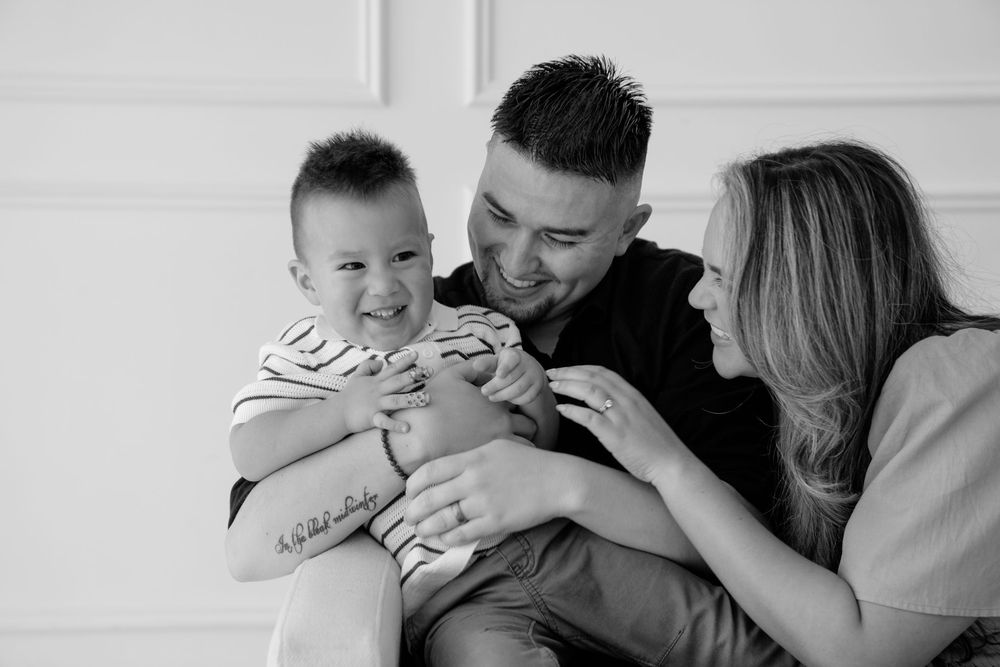 A black and white photo series shows tender moments between parents and their baby in intimate close-up shots.