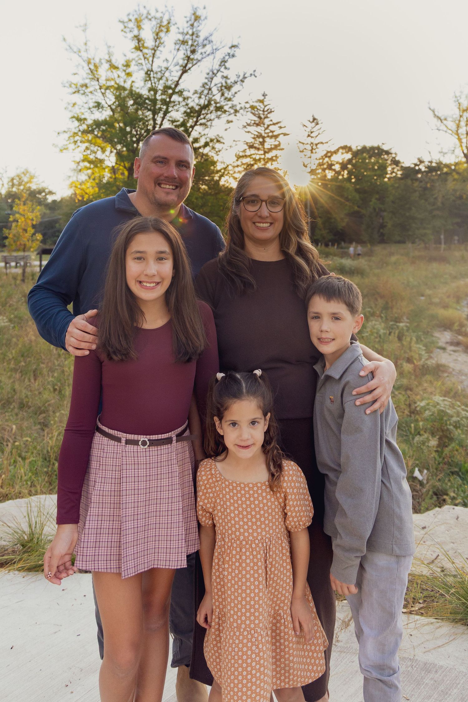 Family members share joyful moments together on outdoor steps.