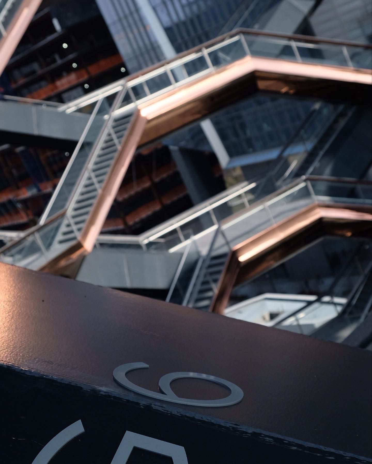 Looking up at the dramatic geometric steel staircases of the Vessel structure in Hudson Yards, NYC.