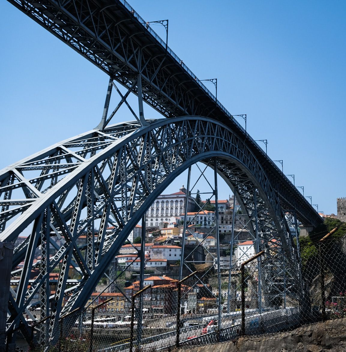 Iconic Dom Luis I iron arch bridge spanning the Douro River in Porto, Portugal.