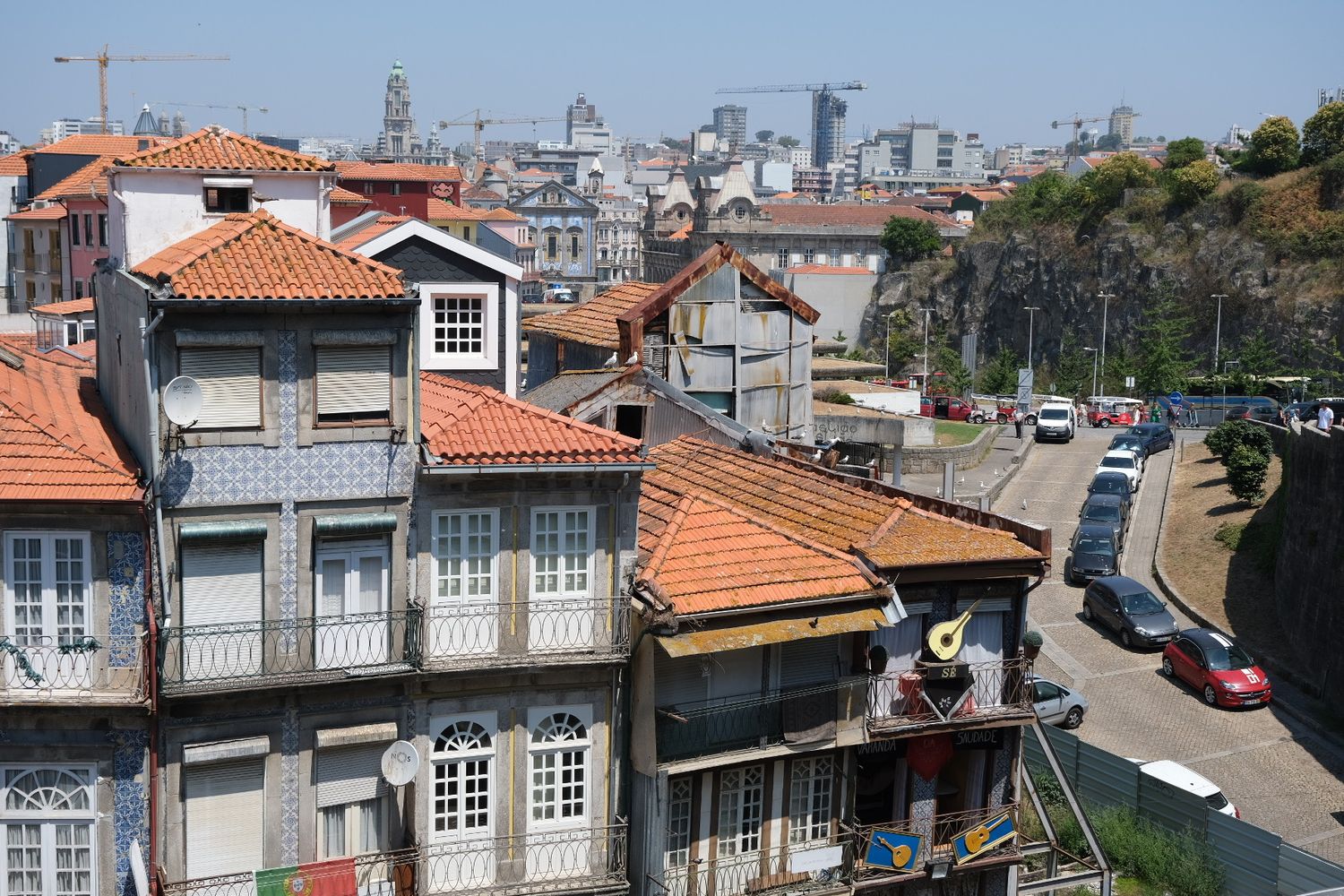 Colorful Porto rooftops with traditional azulejo tile facades overlooking the city skyline.