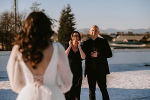 A couple shares an intimate moment during their winter wedding photoshoot in the snow.