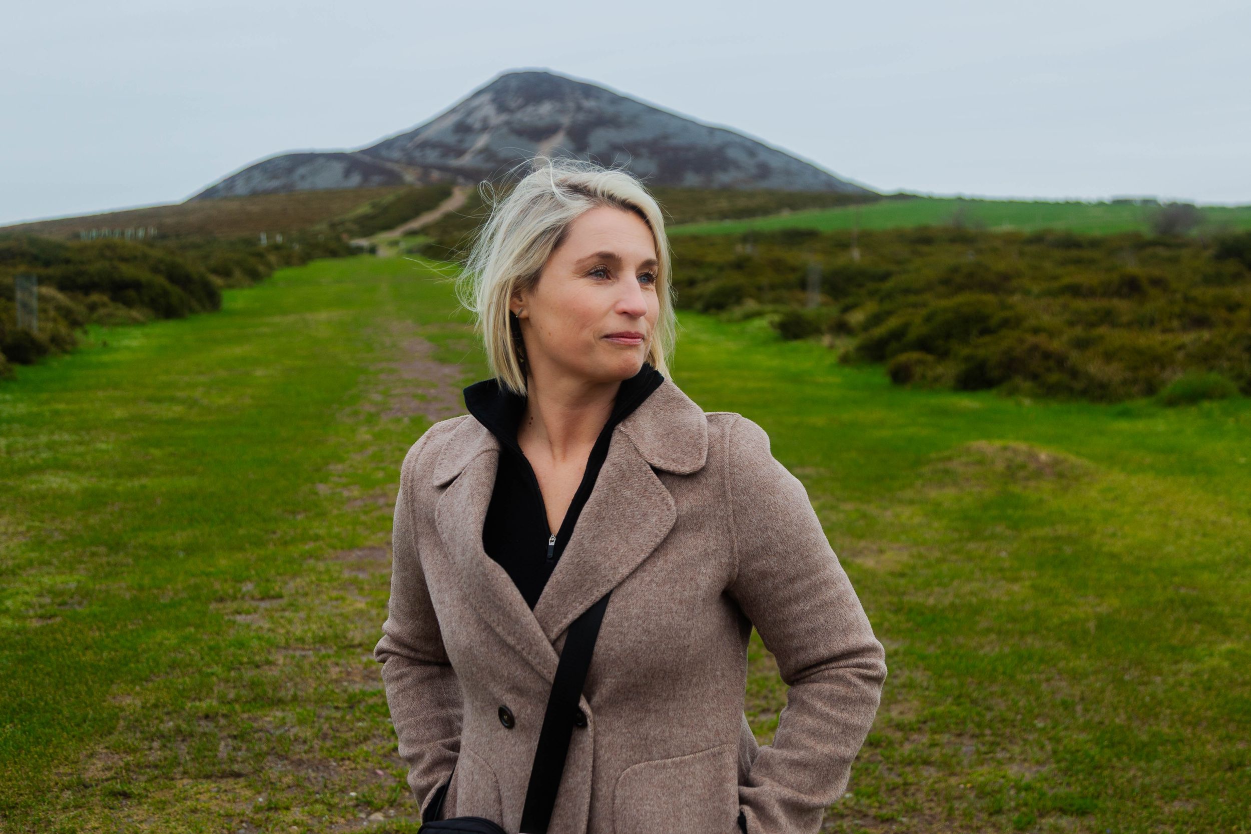 Single traveller posing against the backdrop of the Sugar loaf during a private tour of county Wicklow