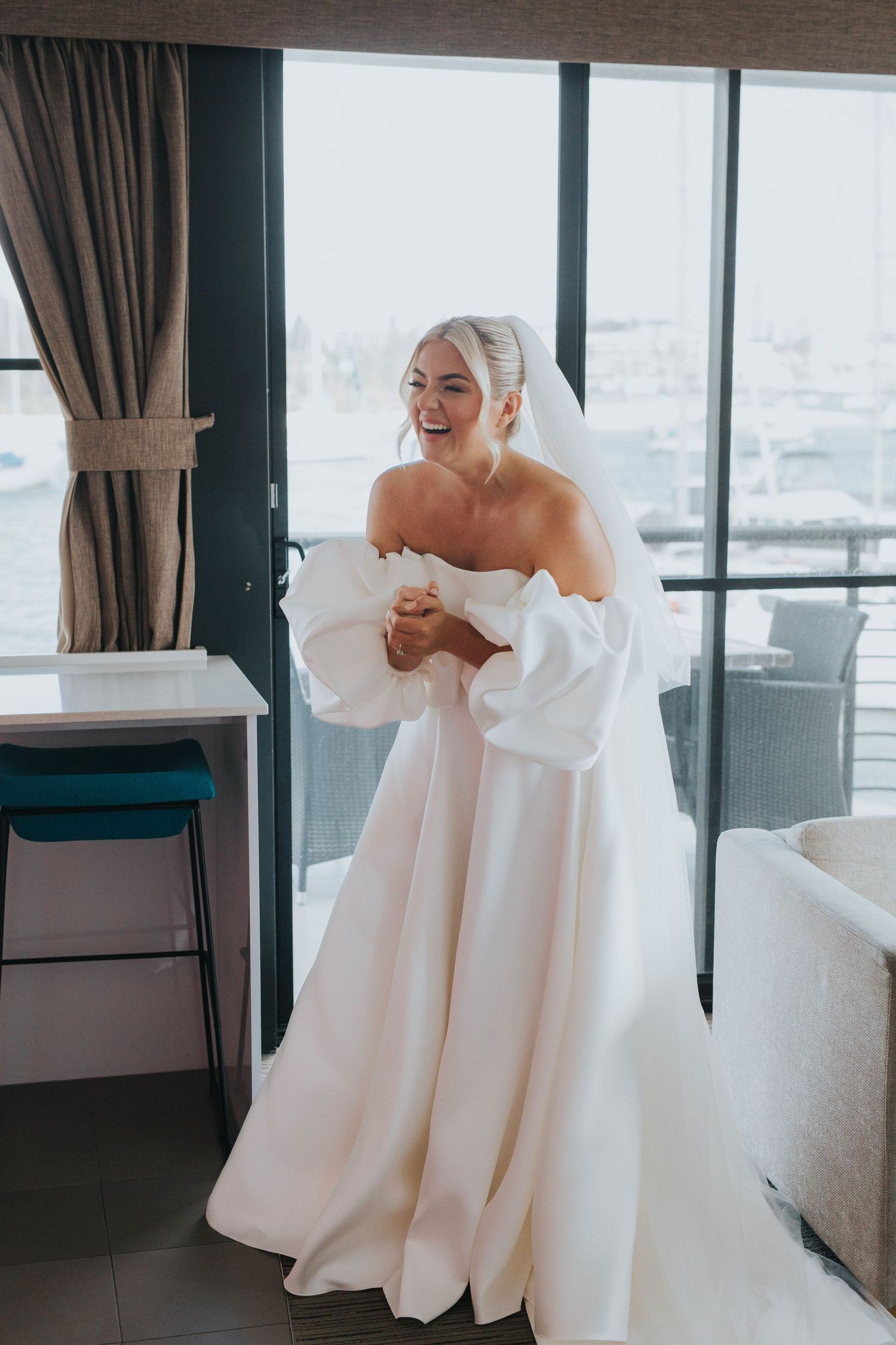 A series of photos showing a person in a white off-shoulder wedding dress with dramatic puffy sleeves.