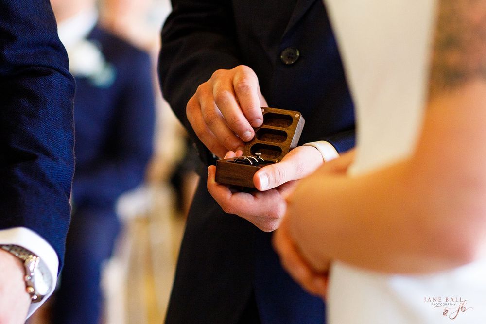 A close-up view of hands holding and using mobile phones in a dimly lit setting.