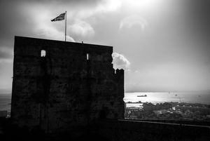 Dramatic skyline silhouettes of coastal buildings seen from a low angle in moody black and white.