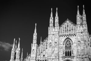 Gothic spires and architectural details of Milan Cathedral captured in striking black and white sequence.