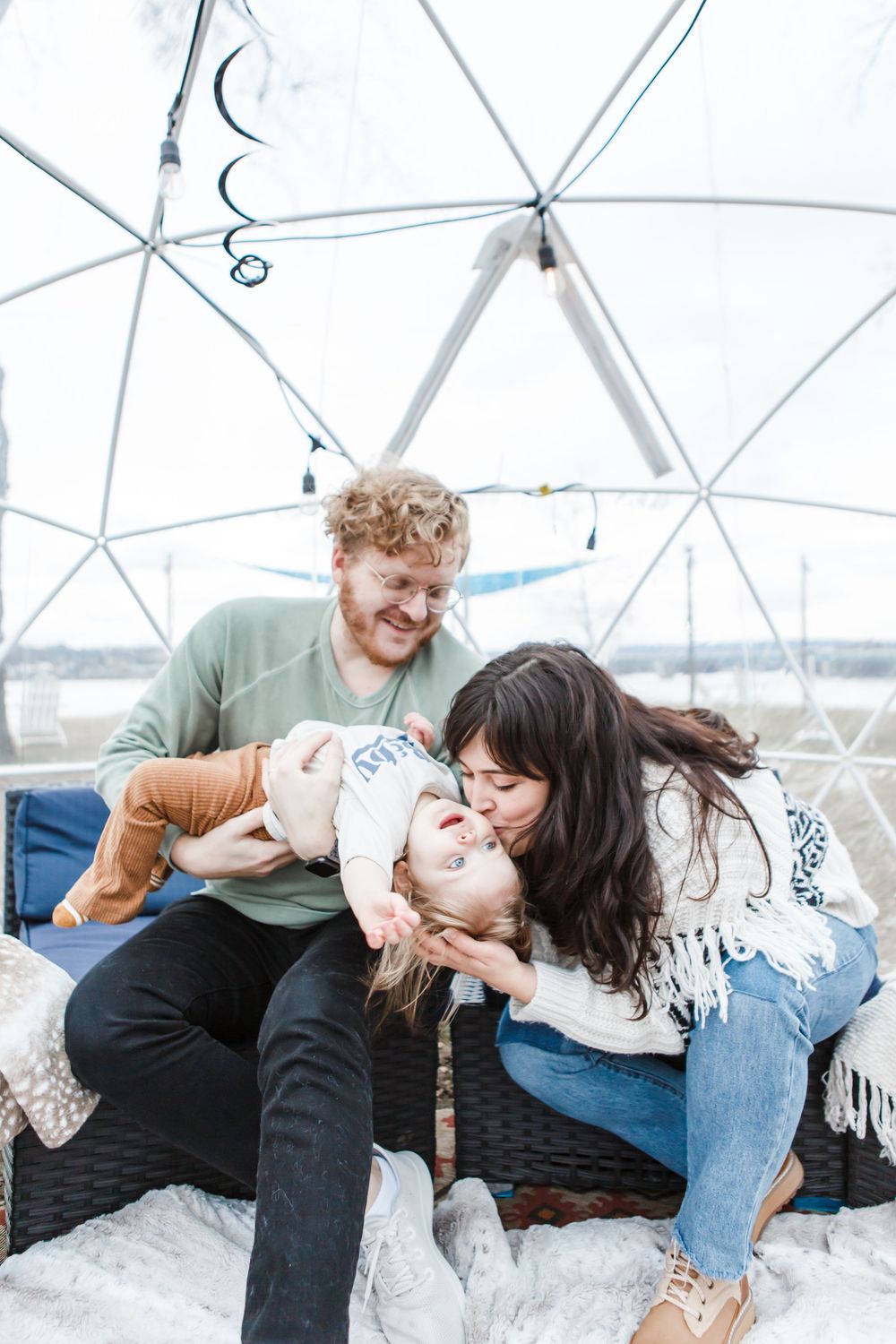 A series of intimate black and white photographs showing playful and candid moments in a geodesic dome greenhouse.