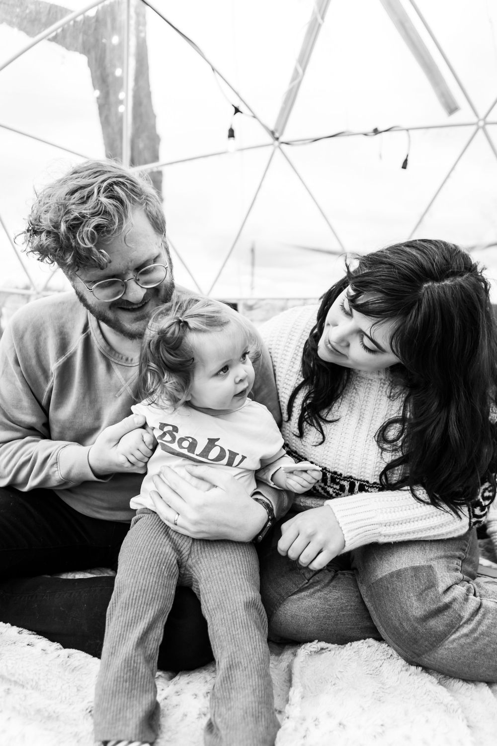 Four black and white photos show tender embraces between a parent and child in sequence.