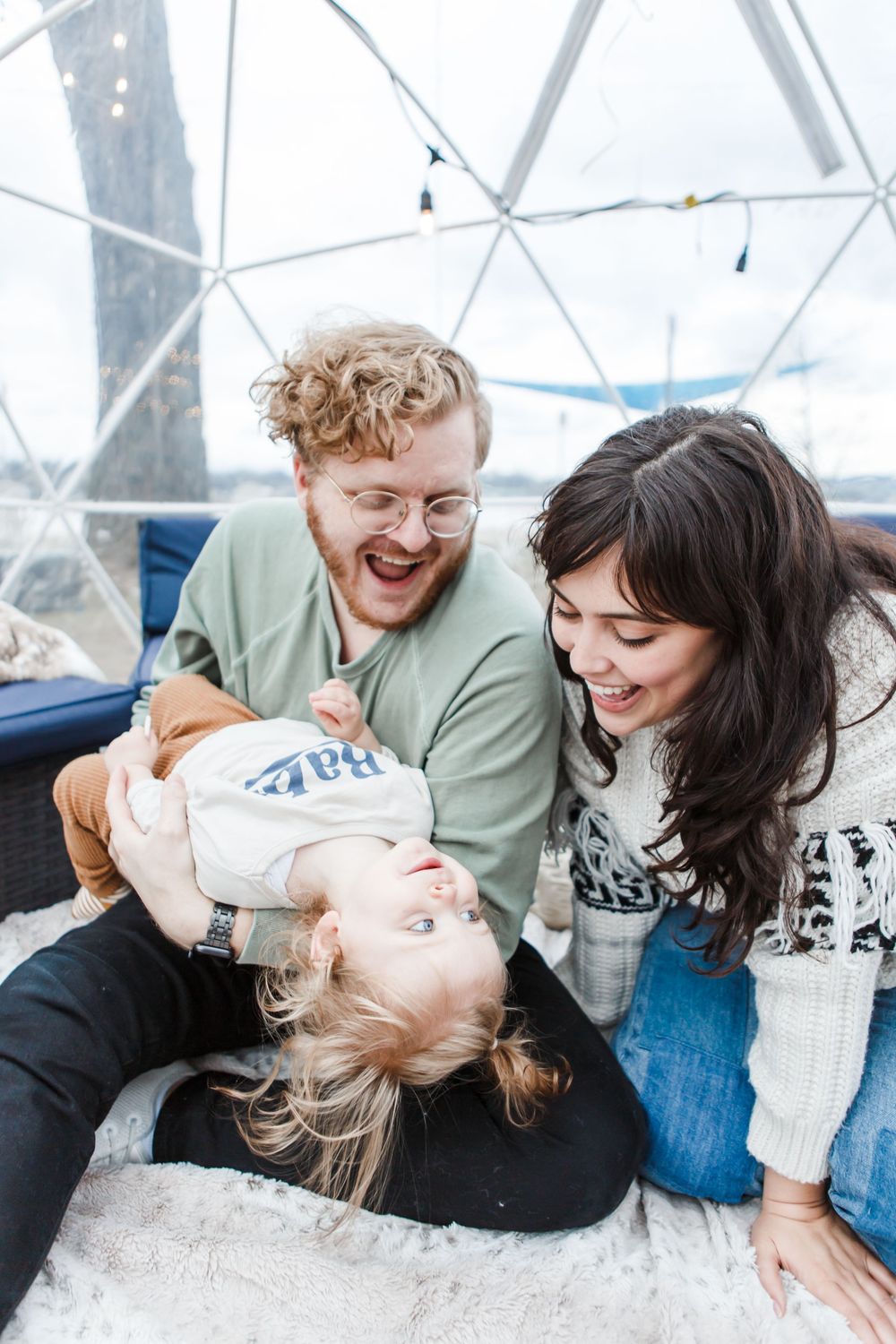 A playful sequence showing a couple in winter clothing laughing and cuddling together on a snowy day.