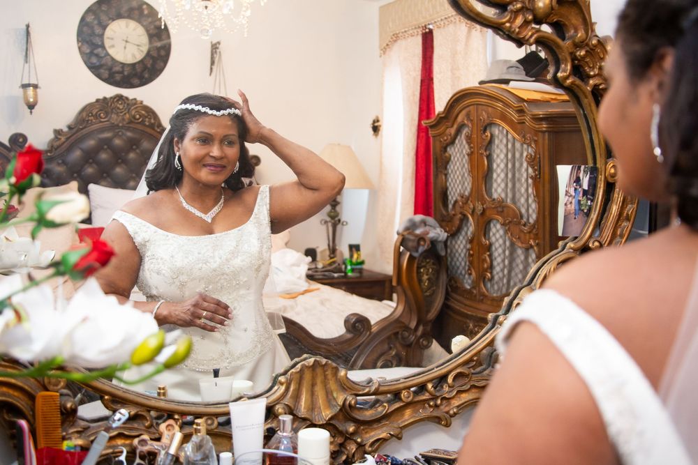 A sequence of silver-framed mirrors reflects elegant wedding decor and floral arrangements in an ornate reception setting.