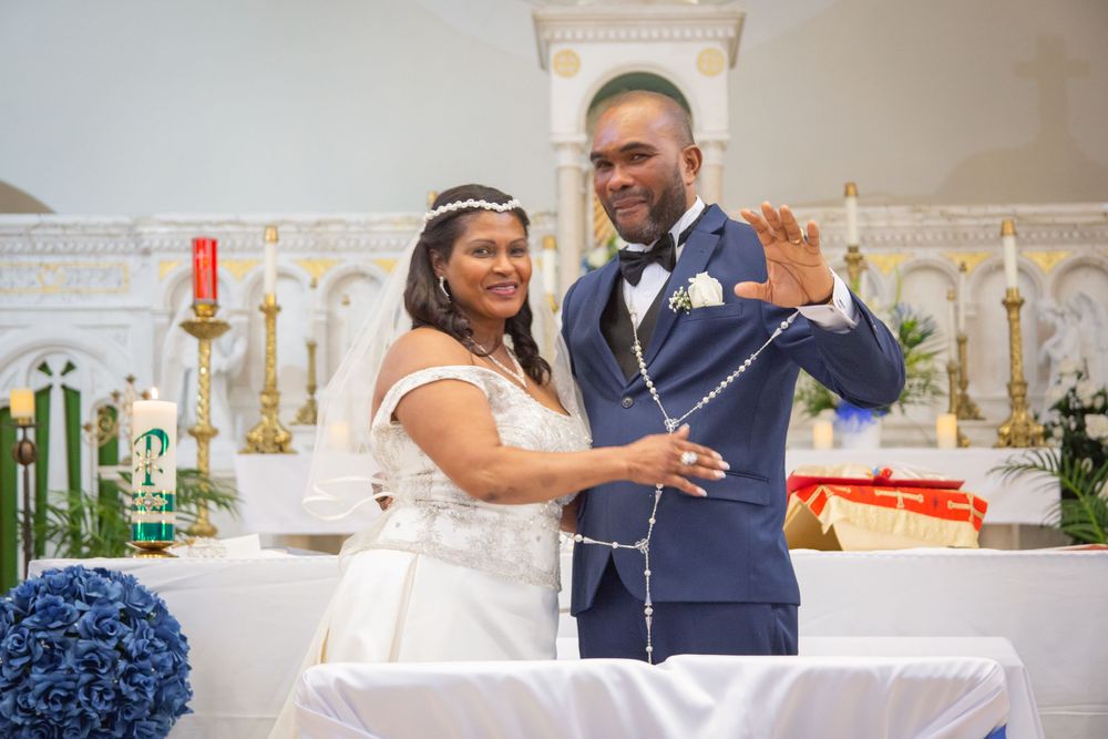 Couple dances and celebrates in traditional wedding attire at an elegantly decorated reception venue.