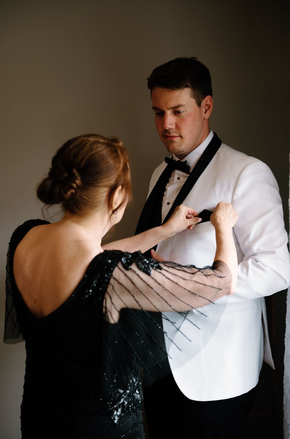 A couple in formal attire performs a romantic dance sequence against a dark background.