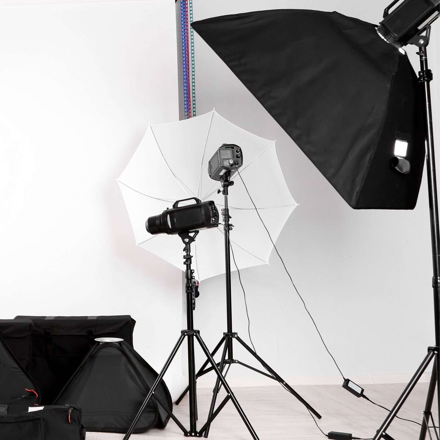 Professional photography studio setup with softbox lighting equipment and white backdrop.