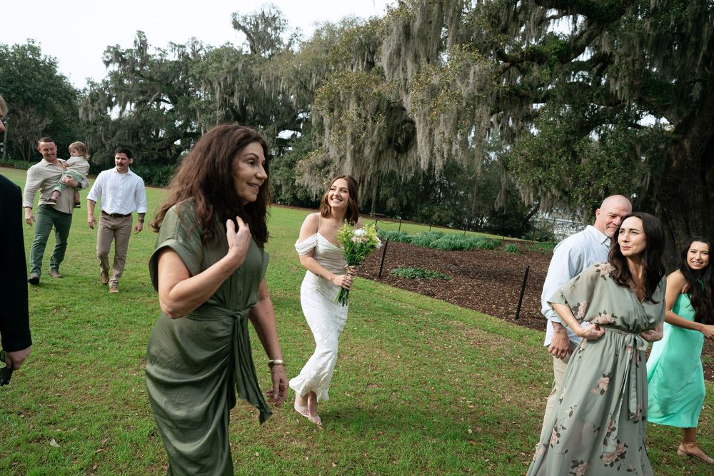 Casual outdoor dance party in a park with moss-draped trees and people enjoying themselves under natural lighting.