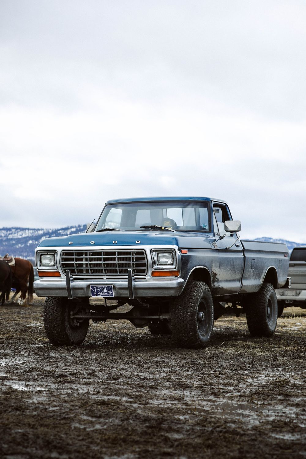 Muddy vintage Ford truck at rodeo grounds in Montana