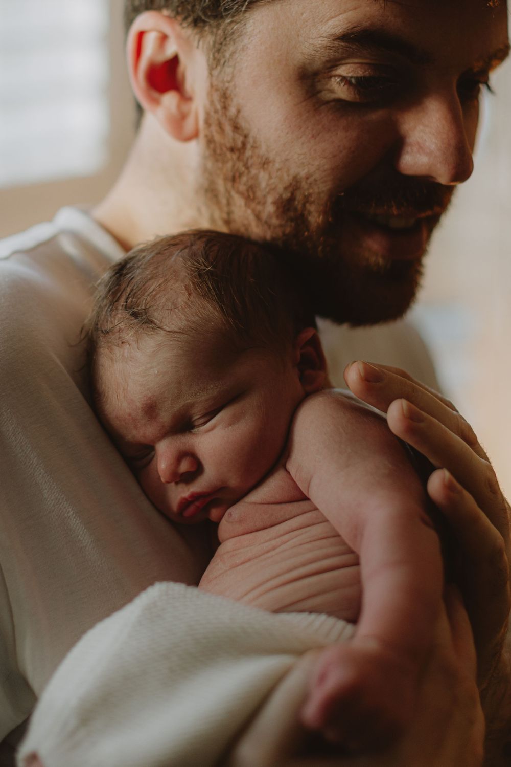 Close-up profile view of tender moment with newborn baby.