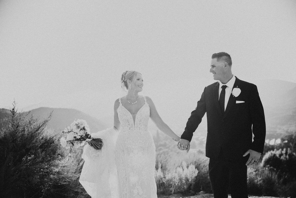 A collection of black and white wedding photos showing couples dancing and celebrating outdoors at a reception.