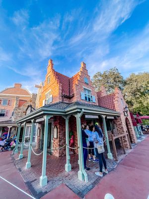 Victorian-style storefront with Dutch architecture at Disney's Magic Kingdom park featuring ornate turrets and mint green columns.