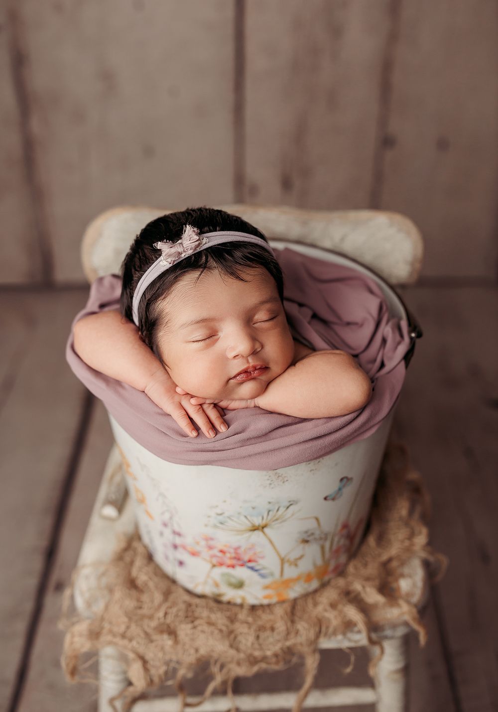 newborn-baby-girl-asleep-while-posed-in-a-bucket-.jpg