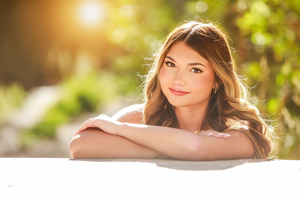 Portrait photos at sunset with golden sunlight creating a warm glow through trees in an outdoor setting.