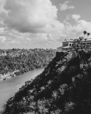A villa on top of a mountain in the Dominican Republic, overlooking a valley and river, shot in black and white.