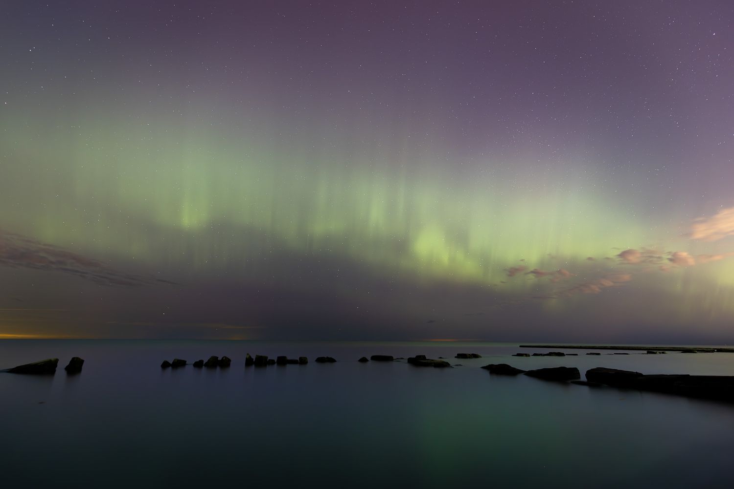 The aurora borealis dancing over Lake Erie in Cleveland at night.