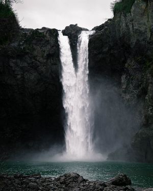 Snoqualmie Falls in Washington during the winter time, dumping tons of water over the cliff.