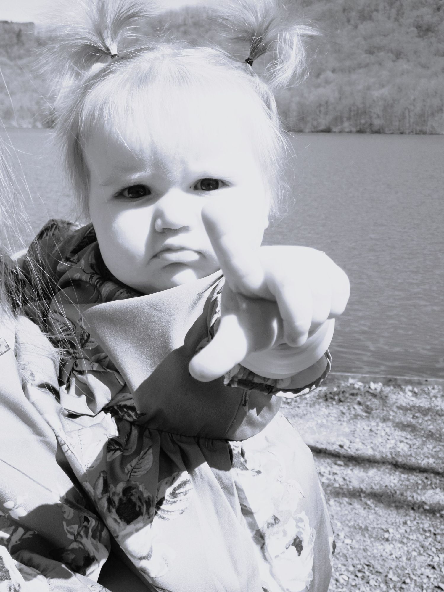 Black and white close-up portrait at a lakeside setting.